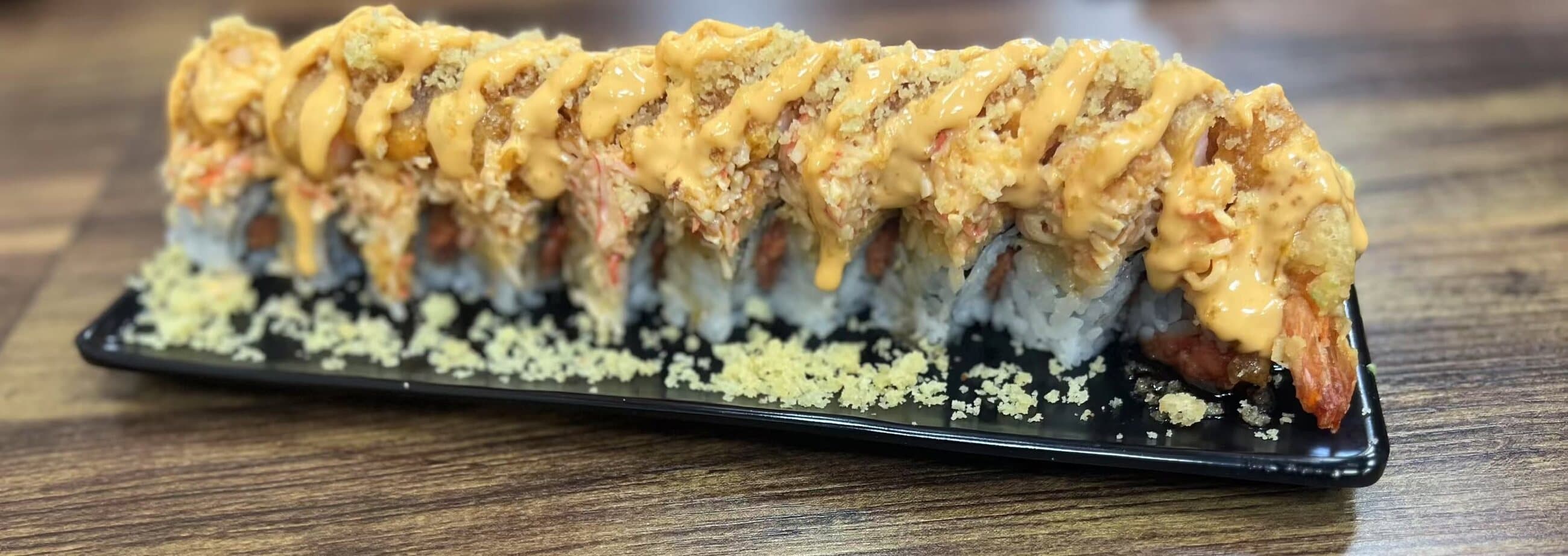 Golden tempura shrimp roll finished with creamy sauce